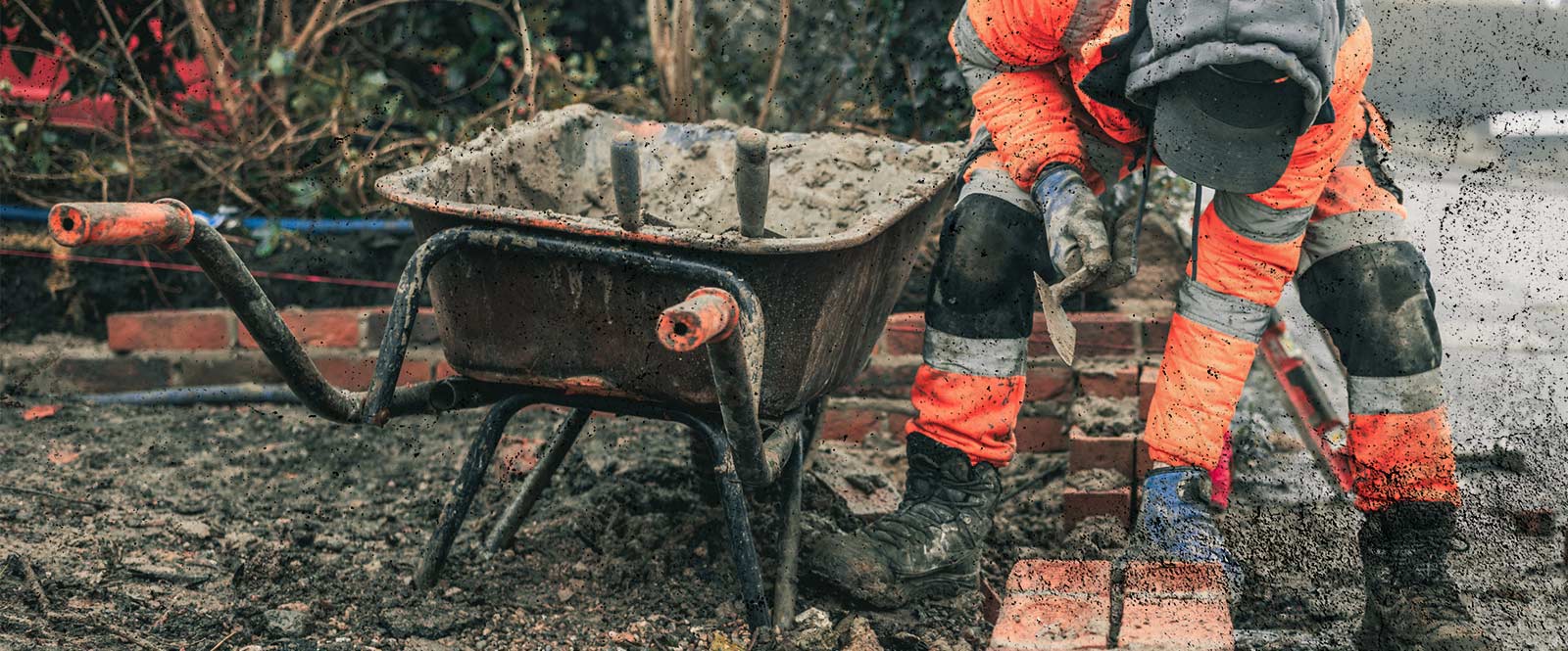 Bricklayer working hard in ill-fitting PPE